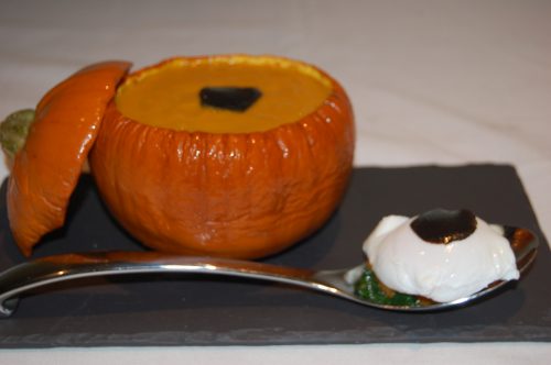 pumpkin soup served in a hollowed out pumpkin